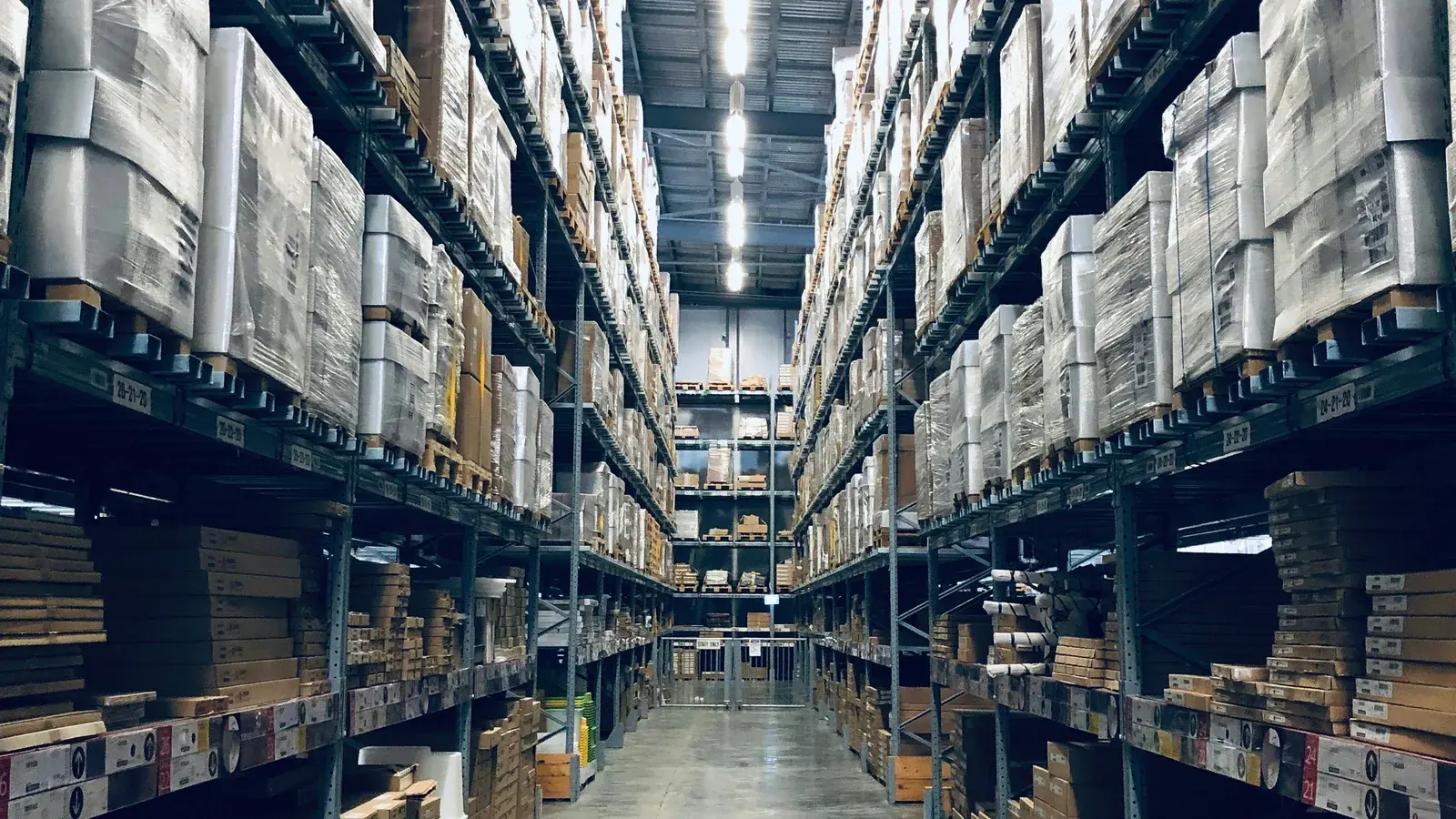 Warehouse aisle with goods stacked on racks