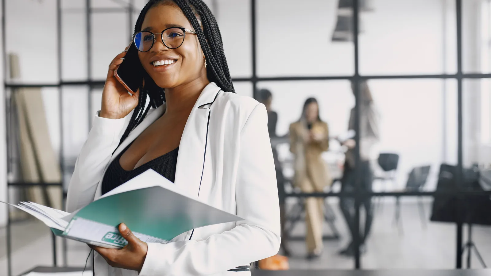 Woman holding a folder while taking a call