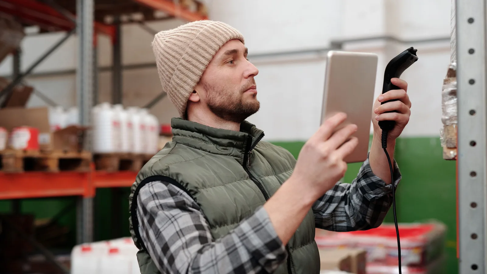 Warehouse worker holding a tablet and barcode scanner