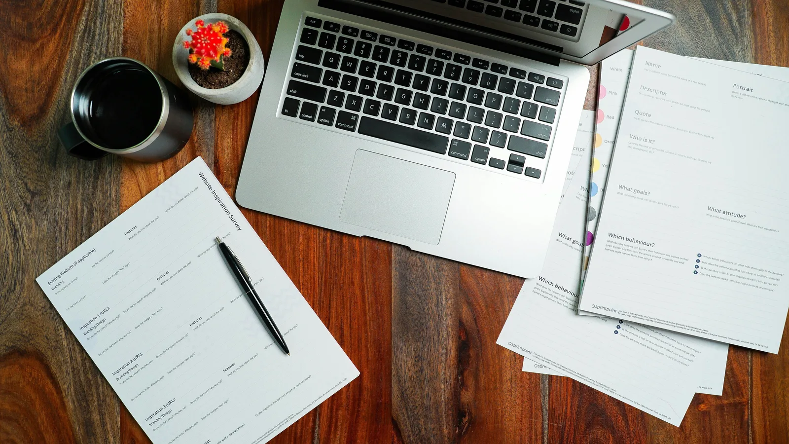 Laptop beside website planning worksheets