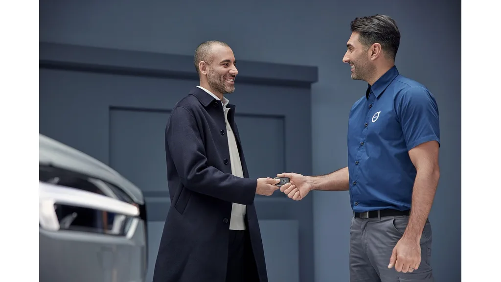 Vehicle salesperson handing car keys to a customer