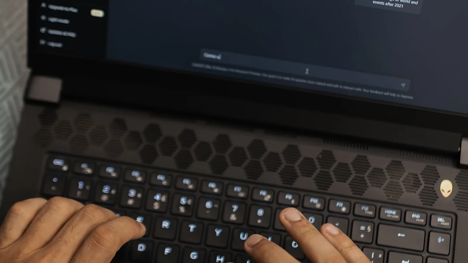 Hands using an AI chat interface on a laptop