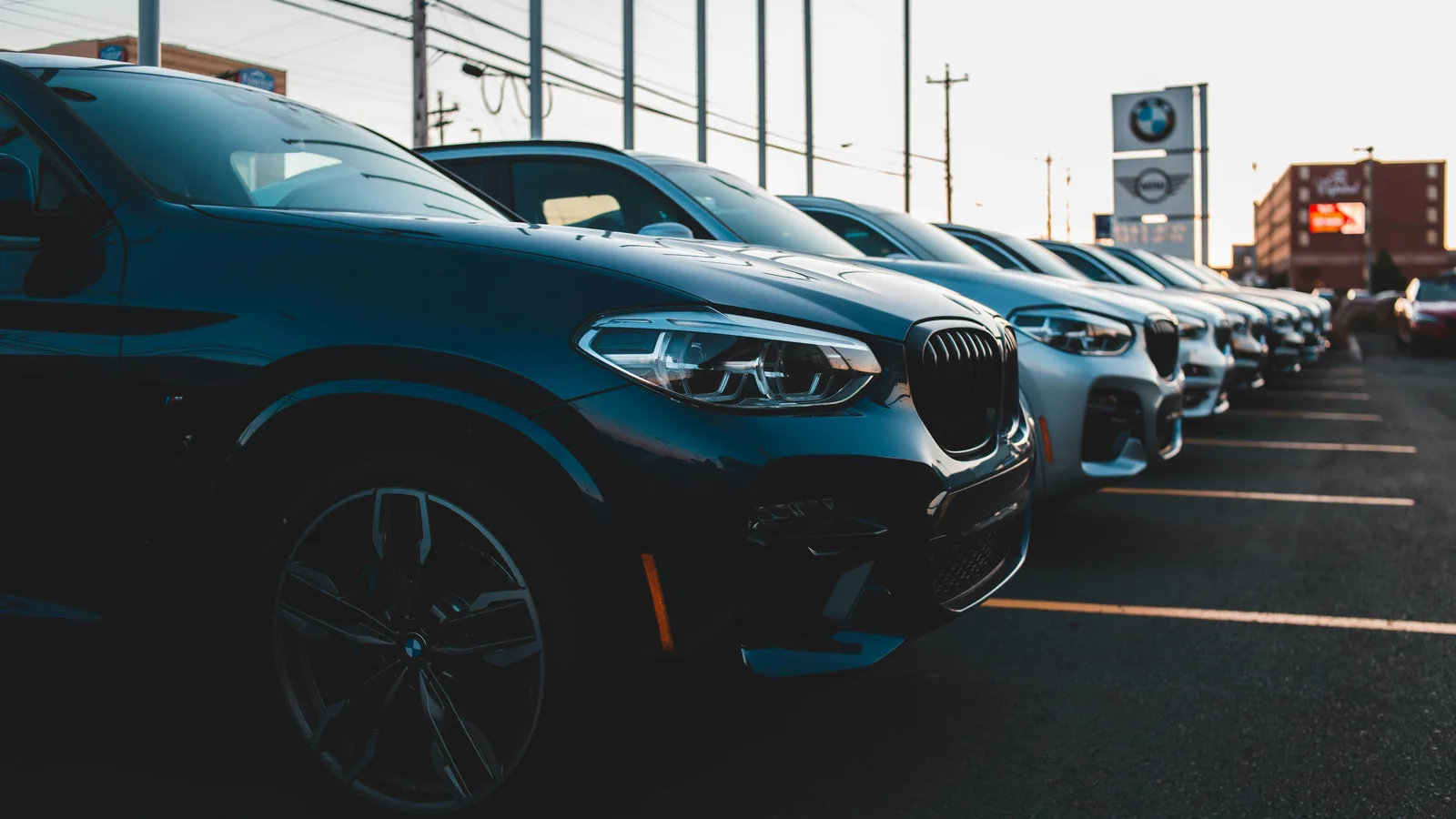 Row of cars parked at a dealership