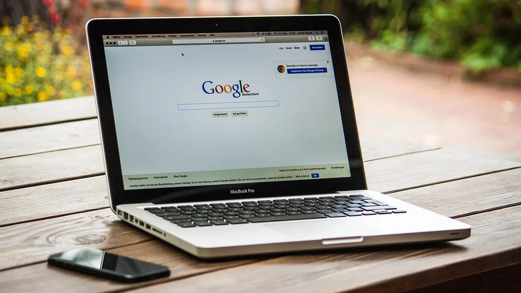 Laptop displaying a browser address bar above the Google homepage