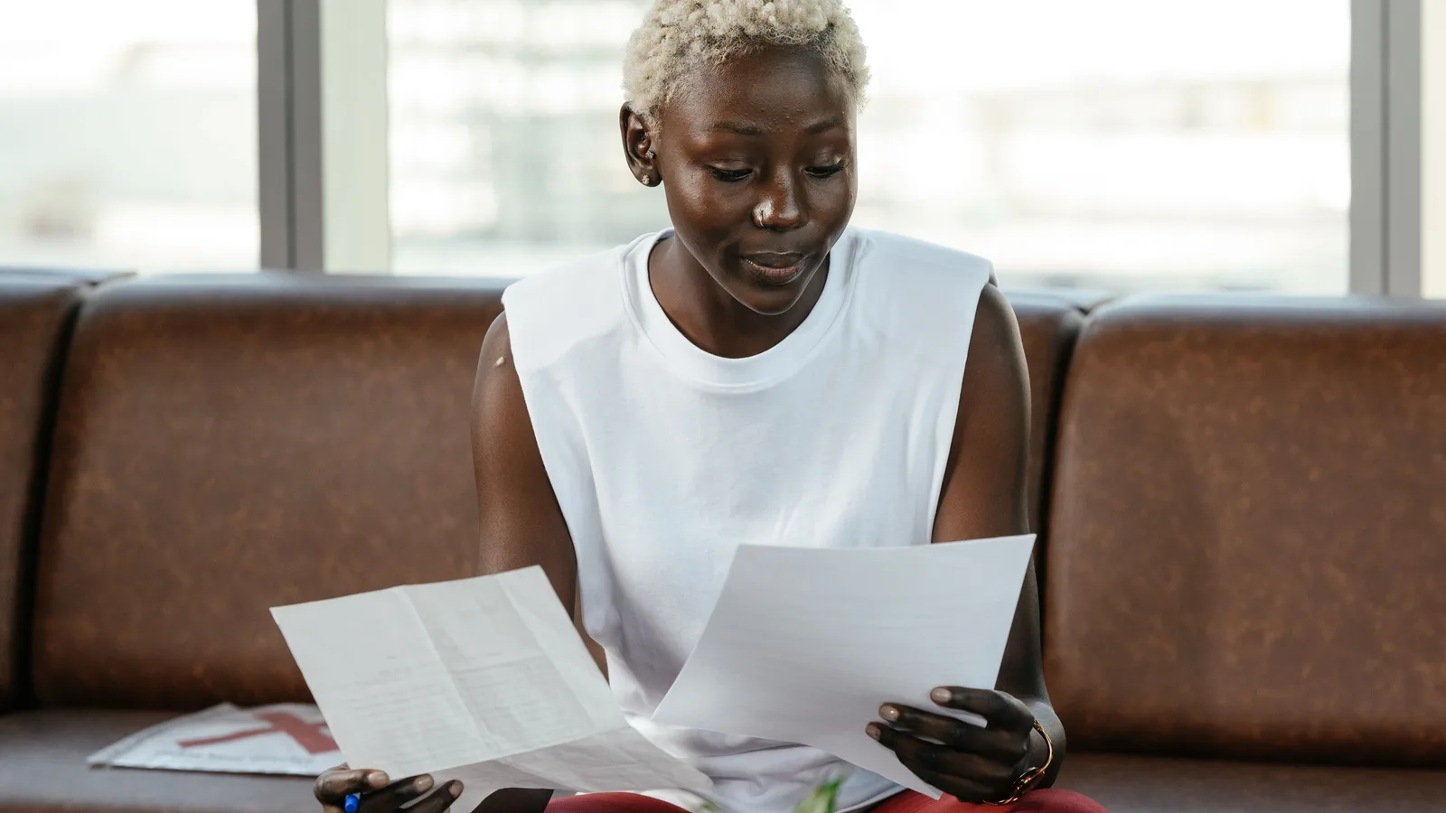 Woman comparing sheets of paperwork