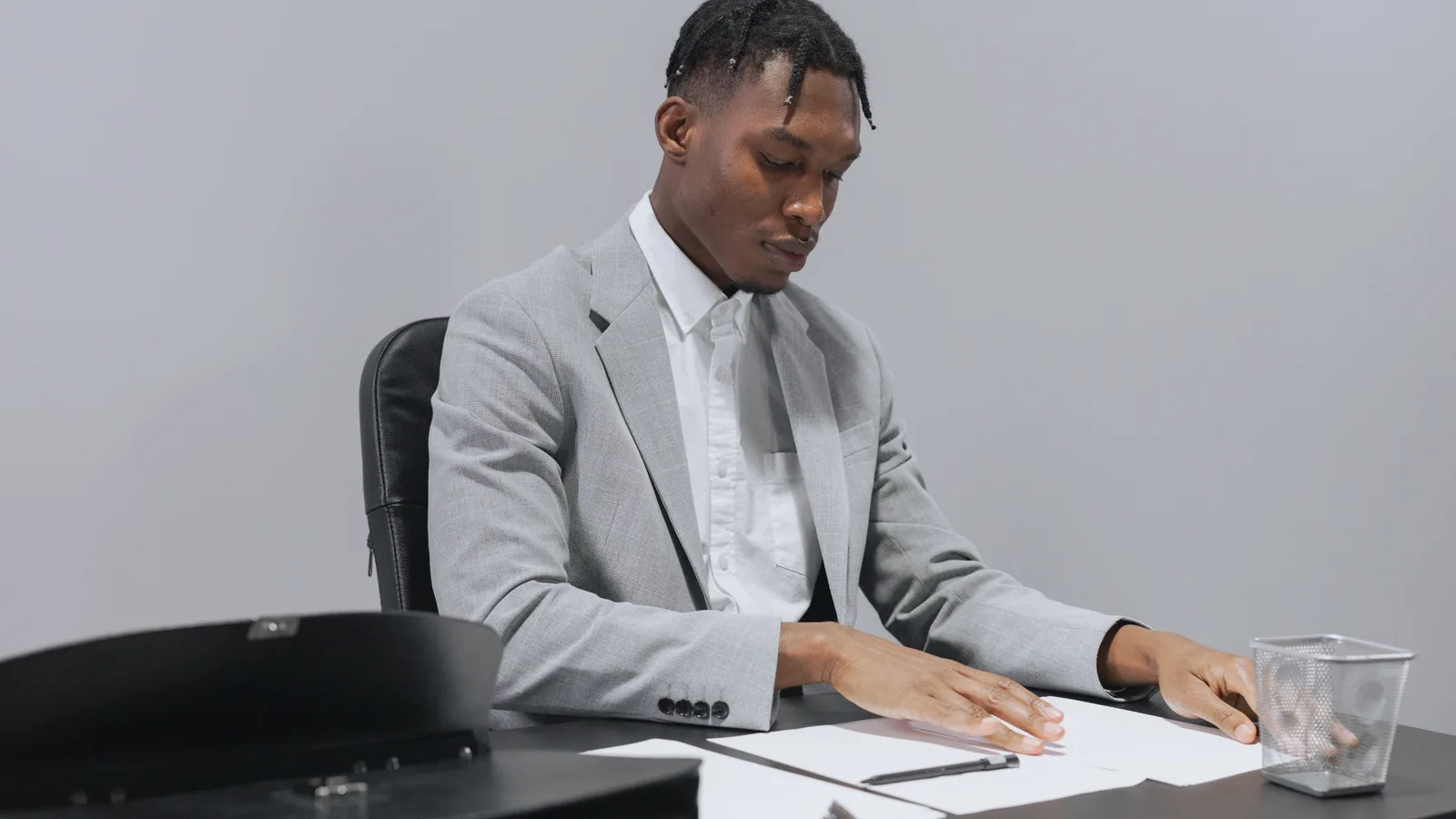 Man reviewing papers at an office desk