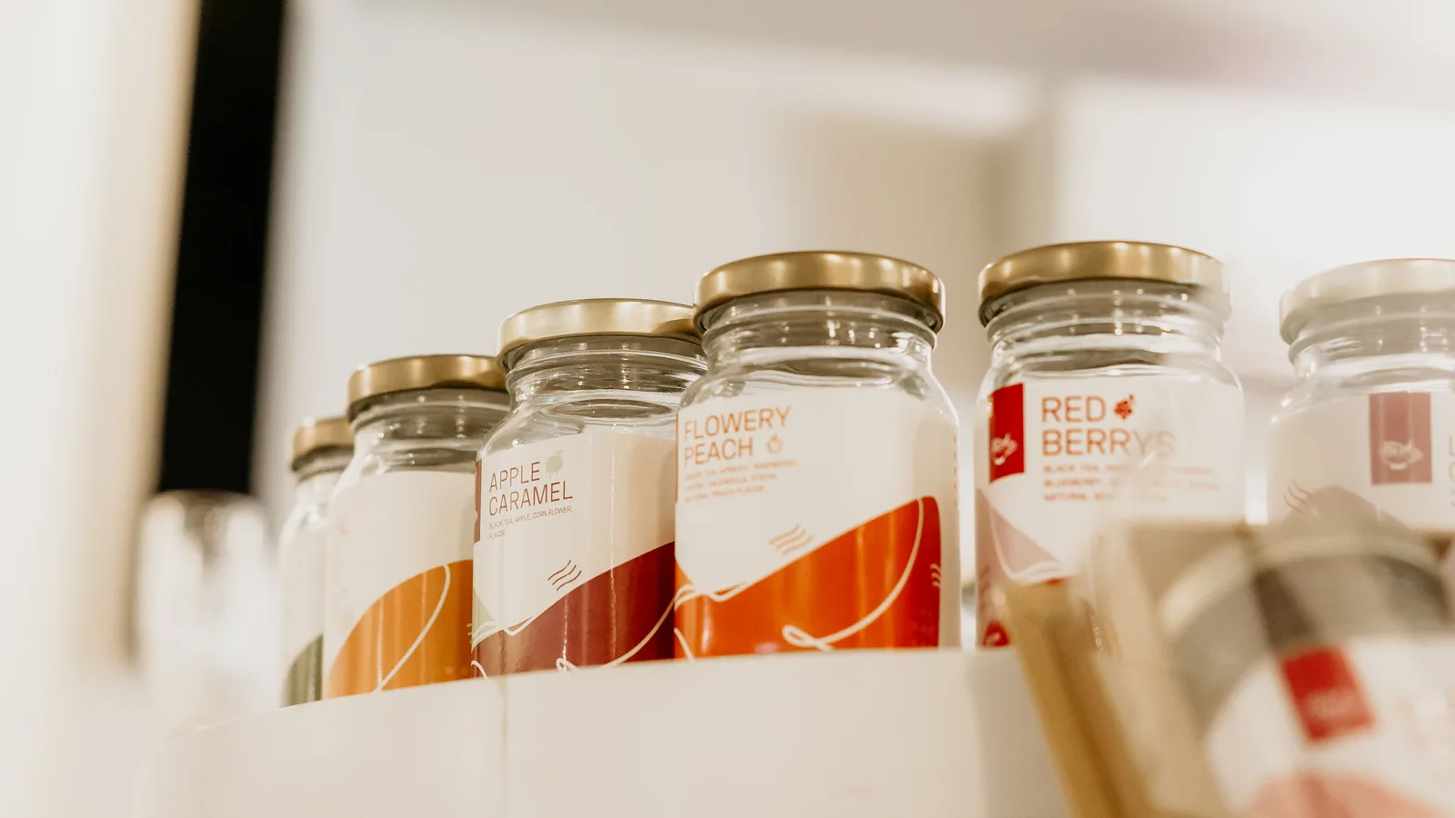 Labelled glass jars displayed together on a shelf
