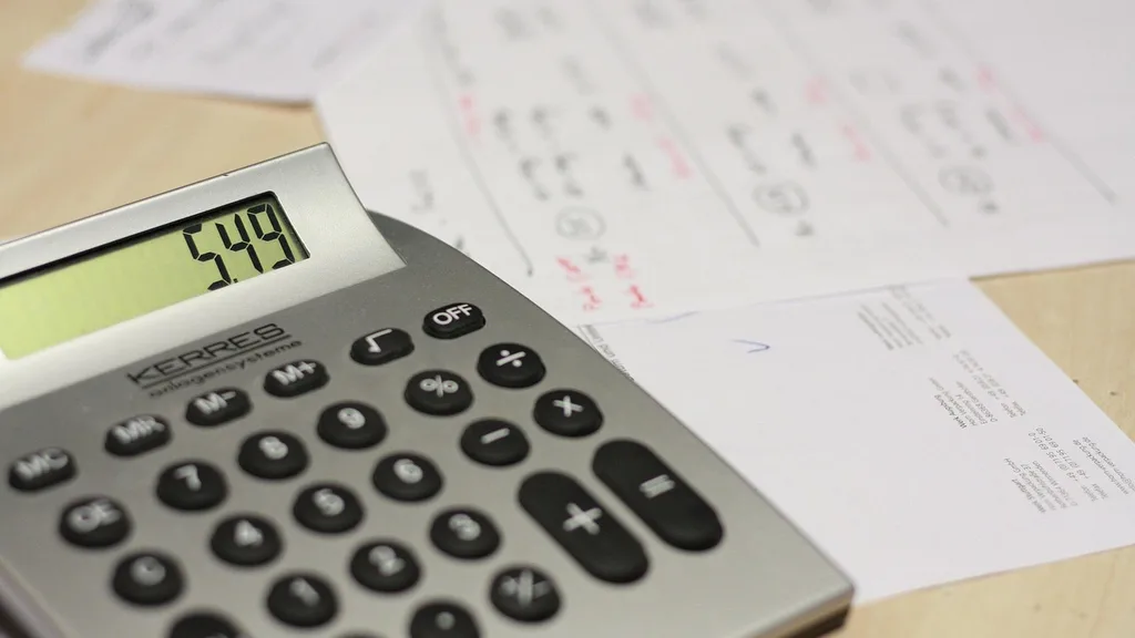 Calculator beside billing paperwork