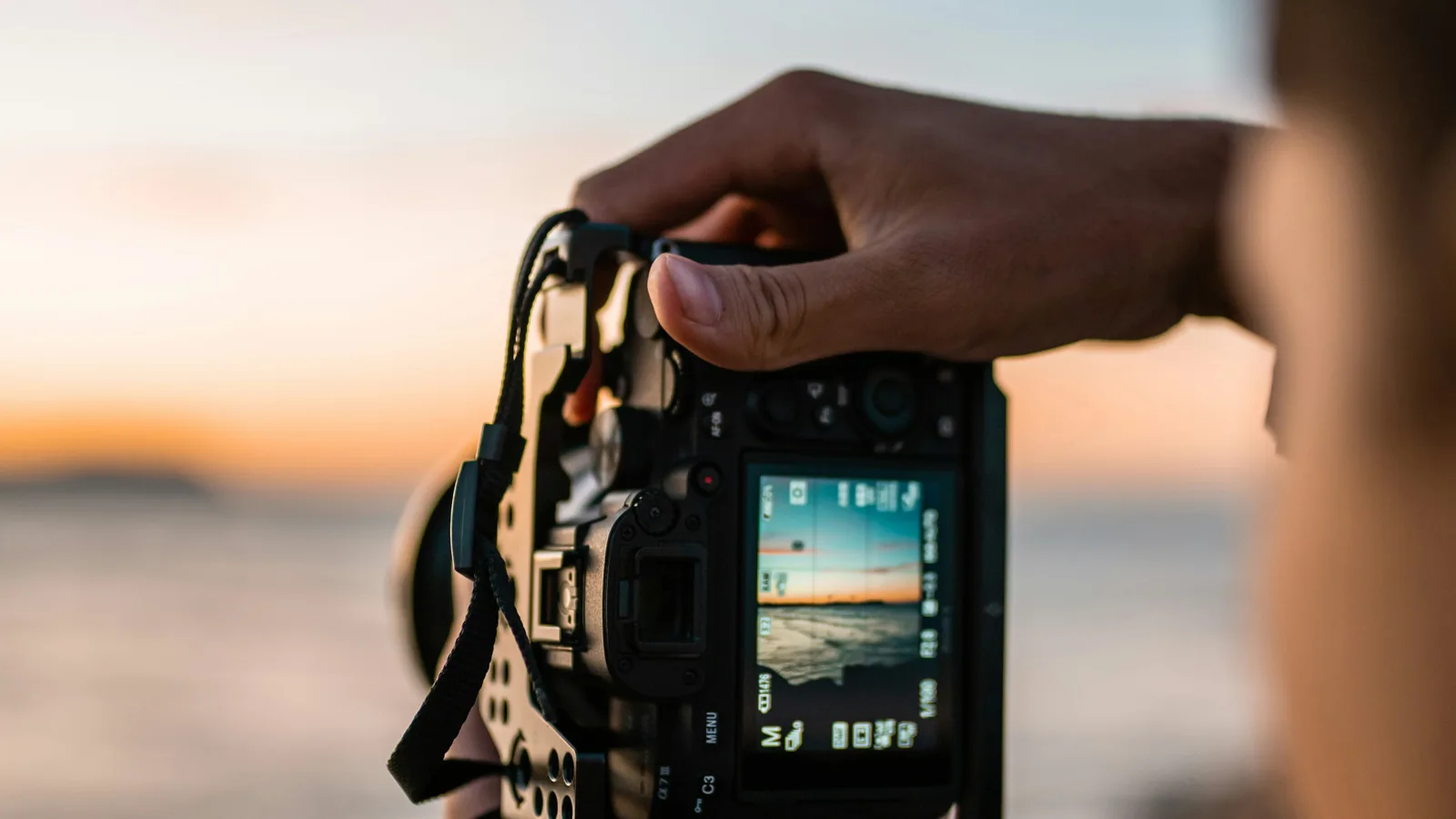 Photographer holding a camera outdoors