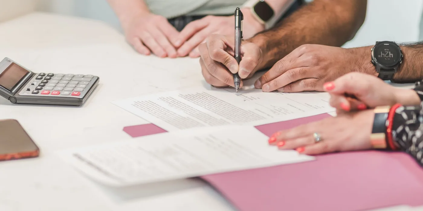 Preparing business paperwork with a calculator