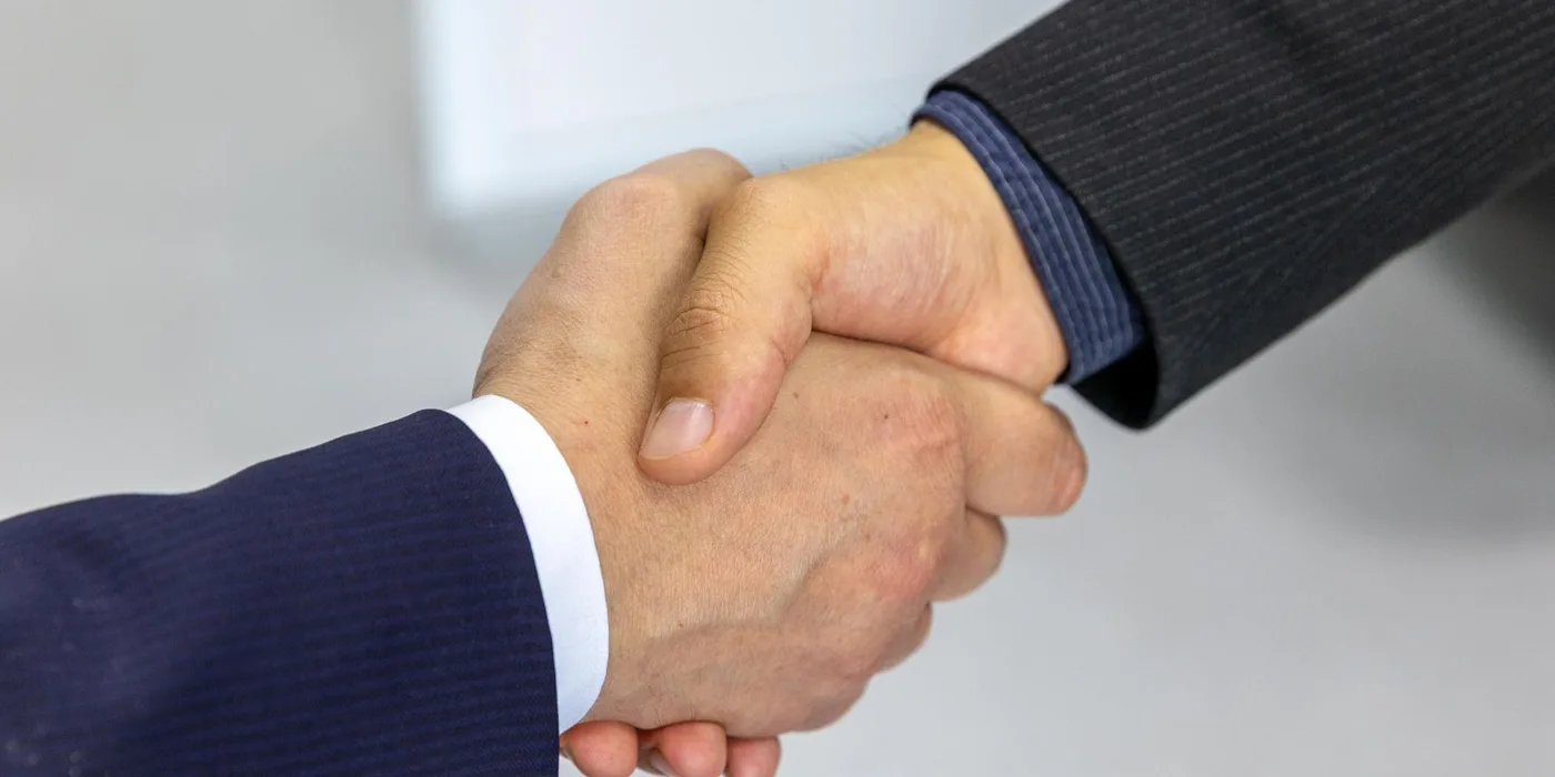 Two business people shaking hands on an agreement