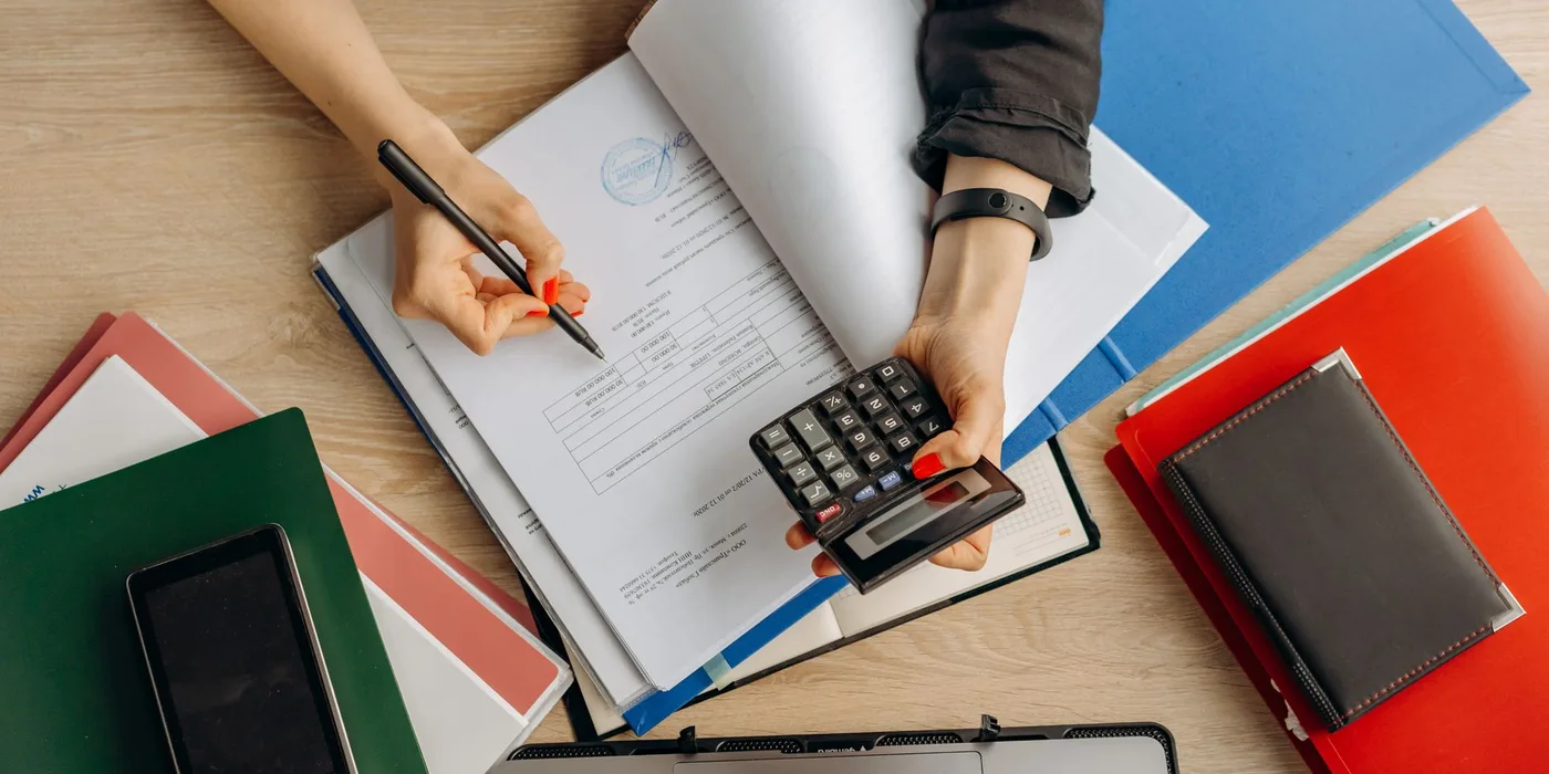 Reviewing tax documents with a calculator